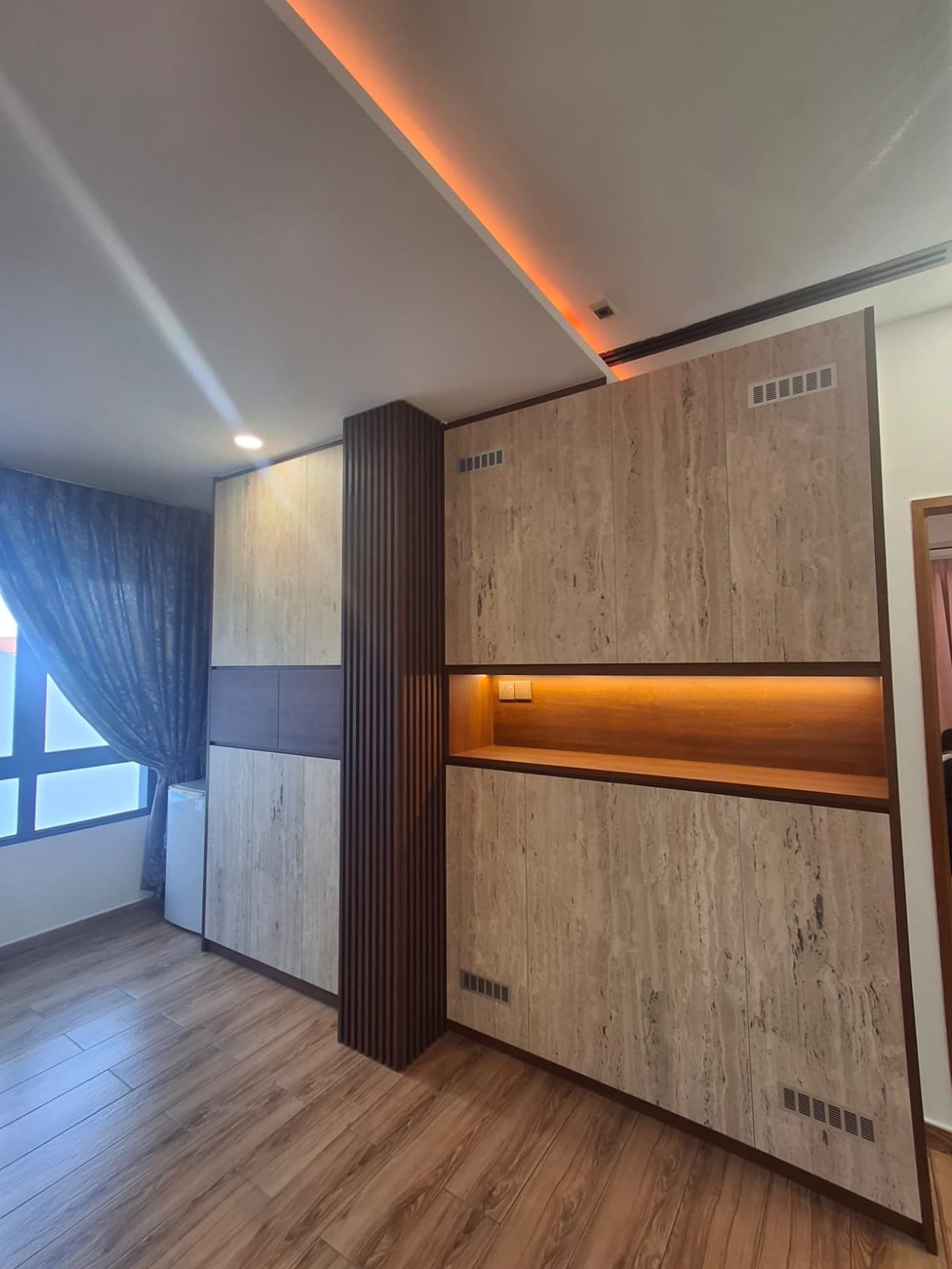 Wood-panelled feature wall with cove lighting