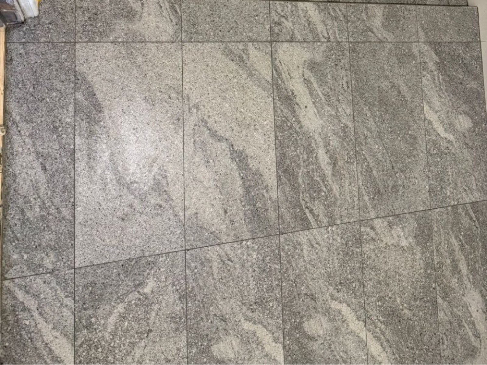 Grey stone floor tiles freshly laid