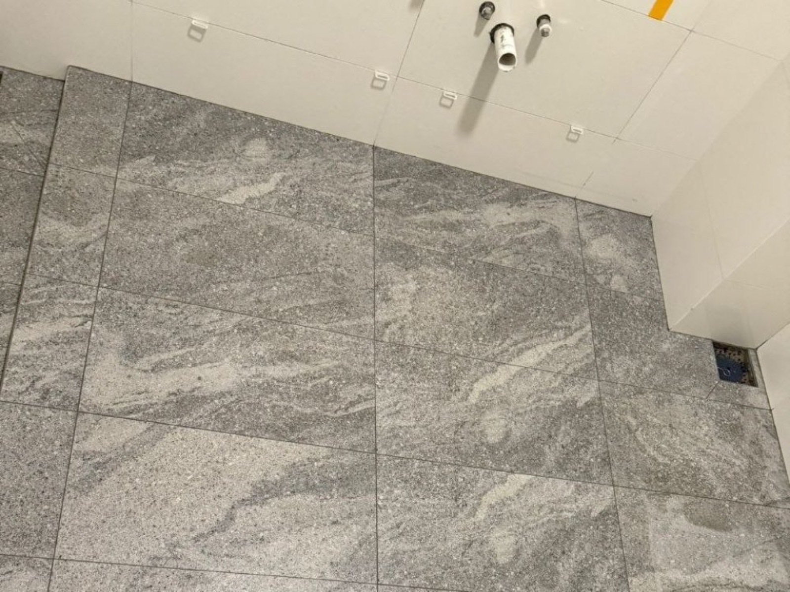 Stone feature-wall tiling with pipe stubs